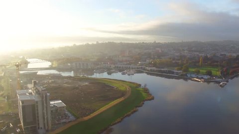 Aerial sunrise shot over the city of Launceston, Tasmania on a misty morning. Still water reflections looking at Peppers, Seaport, and Launceston CBD.