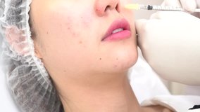 Asian woman getting cosmetic injection in her cheeks. Injection performed at beauty clinic