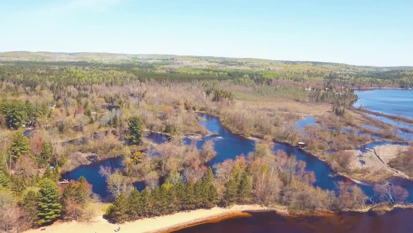 Incredible high altitude aerial view over Round Lake in Bonnechere Provincial Park in Ontario, Canada as the camera tilts down