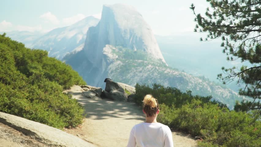 Girl running towards Half Dome in Yosemite
