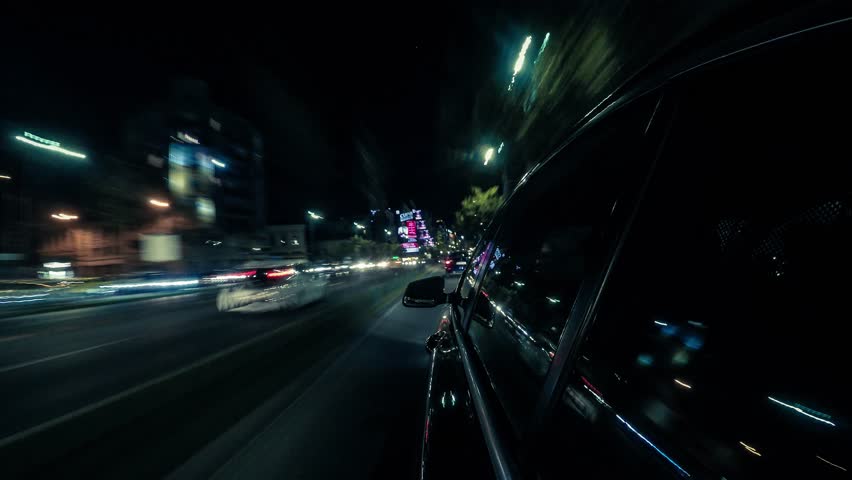 Point of view hyperlapse of a car driving on a city street at night