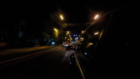 Point of view hyperlapse of a car driving on a city street at night