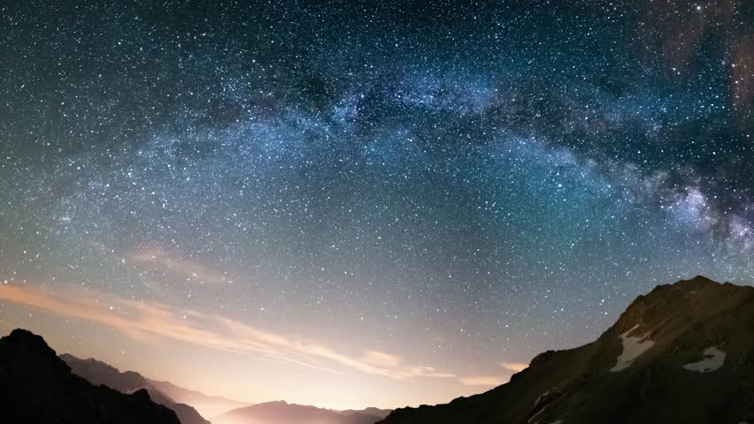 Milky Way arch and starry sky on the Alps. Panoramic view, astro photography, stargazing. Light pollution in the valley below. Royalty-Free Stock Footage #1013518196