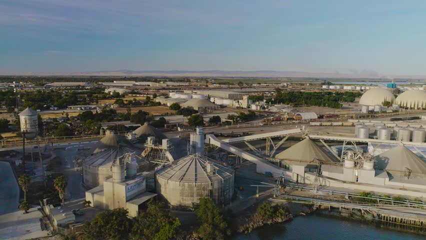 San Joaquin River from Lathrop to Stockton. There are several bridges along with the Port of Stockton. Loaded ships can be seen in the port on the water.