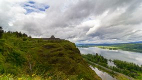 Ultra high definition 4k video of moving clouds and sky over beautiful Columbia River Gorge and historic Vista House on Crown Point with water reflection and freeway auto traffic one summer day UHD 
