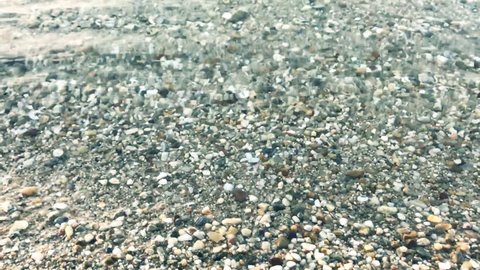 Pebbles on the sea beach,slow motion