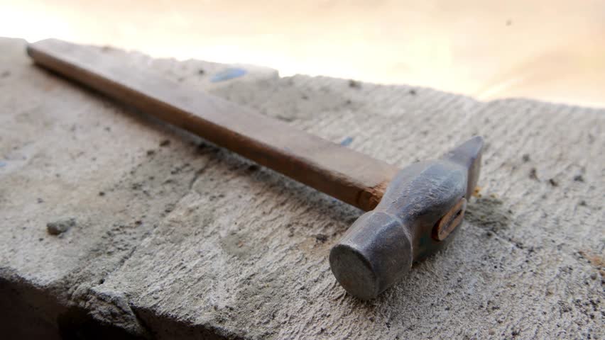 Rusty old the hammer lies on the construction site. | Shutterstock HD Video #1013531750
