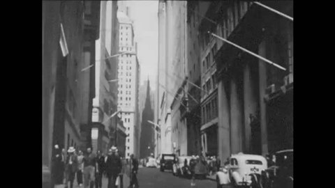CIRCA 1940s - Wall Street, Trinity Church, Federal Hall and a statue of George Washington are shown as well as skyscrapers and the Stock Exchange.