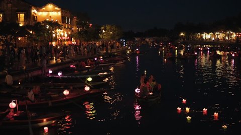 Hoi An, Vietnam - May 10, 2018: Night river Thu Bon view with floating lanterns and boats. Hoi An, once known as Faifo. Hoian is a city in Vietnam and noted as a UNESCO World Heritage Site.