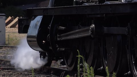 Steam train old style transport close up of steam and wheels on track 4K