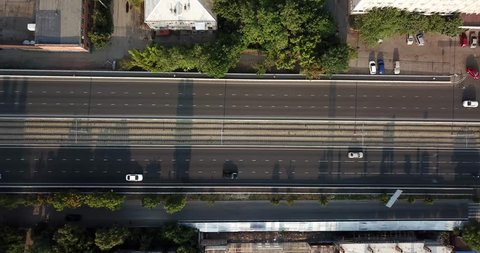 Aerial Drone Flight top down View of freeway busy city rush hour heavy traffic jam highway.  Aerial view of the vehicular intersection,  traffic at peak hour with cars on the road, over the bridge.