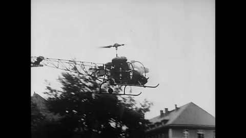 CIRCA 1962 - A helicopter drops Audie Murphy near the border of the iron curtain.