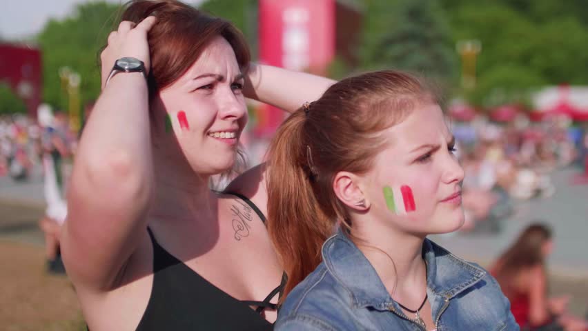 Girls watch football match in fan zone