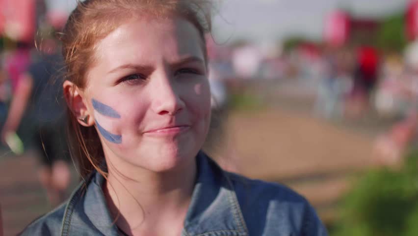 Close up view of young girl with Argentinian flag on cheek