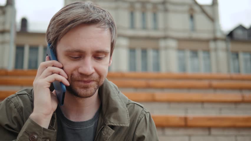 Close up of a young man enjoying talking on a mobile phone in park grass field tourist student. Royalty-Free Stock Footage #1013556581