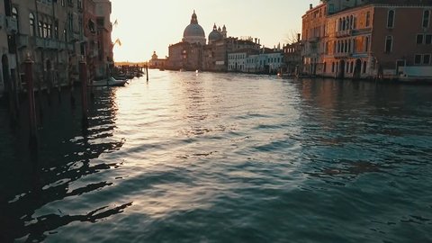Aerial flight down Venice canal at sunrise in Italy