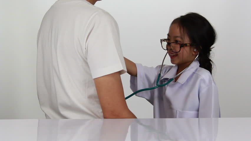 Asian little girl playing as doctor examining her father with Stethoscope | Shutterstock HD Video #1013564642