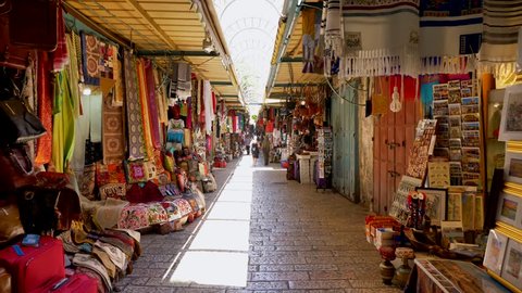 Jerusalem, Israel - July 9, 2018: People at Jerusalem old city market - Walking footage.  Everything from Jewelry and ceramics to fresh traditional food can be found in this market.