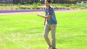 Slow motion video of teen doing flips on a grassy field 