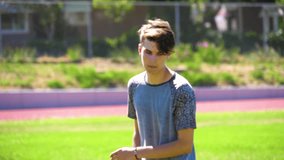 Slow motion video of teen doing flips on a grassy field 