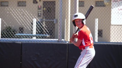 Slow motion video of youth baseball player hitting a home run