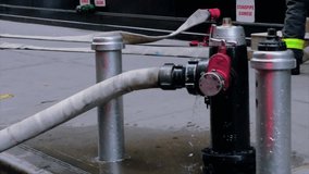 Clip of a Fire Hydrant being used in New York City by the New york fire department during a building fire in the financial district of manhattan.