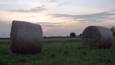 big bale of hay at sunset in the field North italy