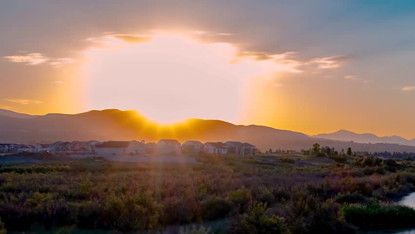 Panning time lapse reveals a golden sunset and beautiful river ladscape as the scene transitions to night
