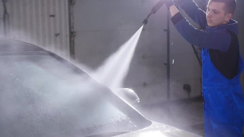 Man washes car with high pressure water