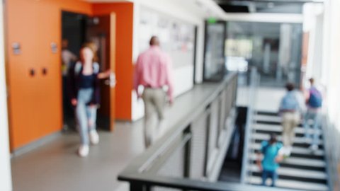 Defocused Shot Of Busy High School Corridor During Recess With Students And Staff