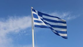 Video shot of greek flag with blue background
