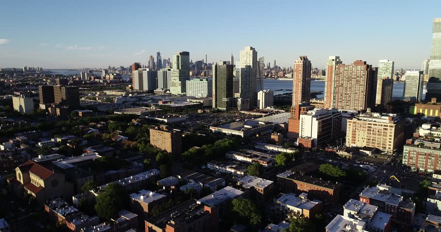 Aerial panorama reveals Jersey City buildings, waterfront neighborhoods, rail lines, and the Manhattan skyline beyond, 2018.