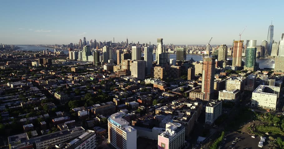 Aerial drone footage of the neighborhoods, highways and skyscrapers surrounding Jersey City, New Jersey. The footage was shot in the summer of June 2018.