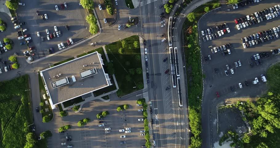 Top-down aerial view surveys a Jersey City intersection, parking areas, roads, trees, and nearby apartment blocks, 2018.