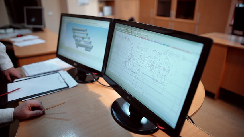 Engineers view the drawing of the part on the screen of the monitor Royalty-Free Stock Footage #1013631788