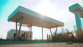 Old dirty deserted gas station. U.S. Route 66. crisis road 66 fueling slow motion video. closed supermarket store shop Abandoned gas station oil end of fuel lifestyle the world apocalypse petrol. main