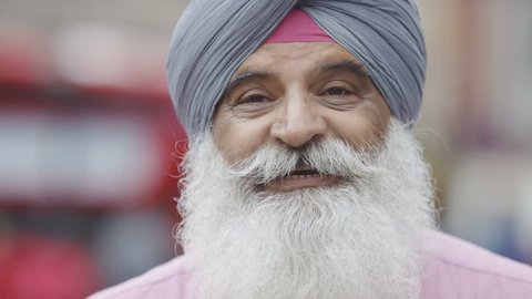 Older Indian male talking to camera 