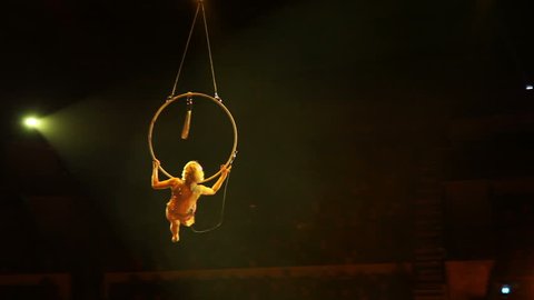 Young girl performs the acrobatic elements in the air ring
