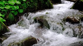 Small mountain stream close up slow motion video
