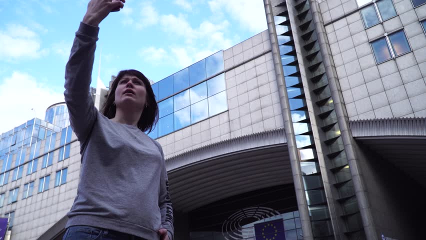 Lady tourist make selfie on smartphone near the European Parliament in Brussels. Belgium.