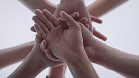 Low angle shot of a team doing a hands in cheer before the big game. Huddle. - Powered by Shutterstock - Get 15% off with code: PIKWIZARD15