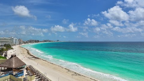 Aerial time lapse view of the hotels and resorts along the beautiful turquoise  water Caribbean beach 