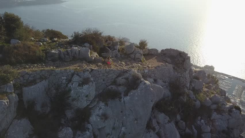 girl running on french rivera near monaco , aerial video