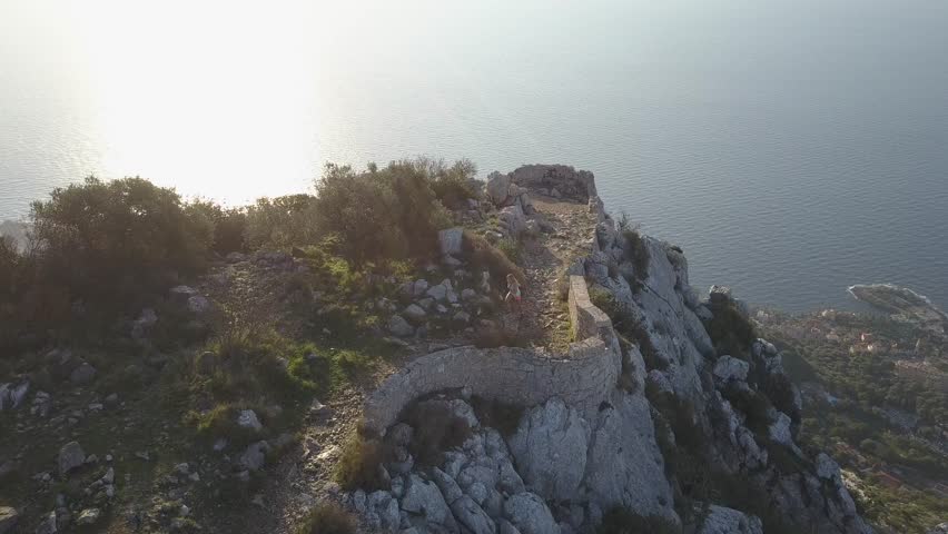 girl running on french rivera near monaco , aerial video