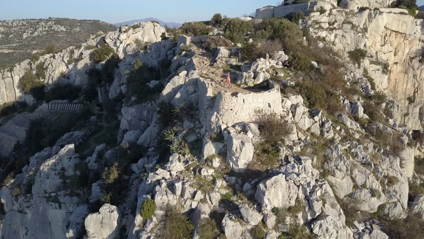 girl running on french rivera near monaco , aerial video