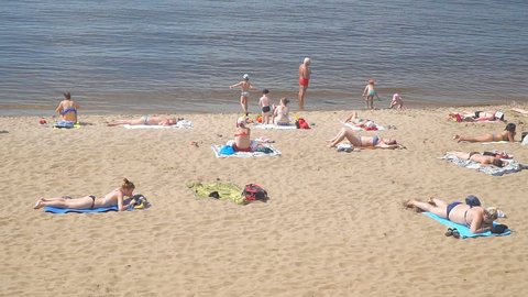 SAMARA, RUSSIA - JUNE 19, 2018: People on the beach. Volga river. Slow motion