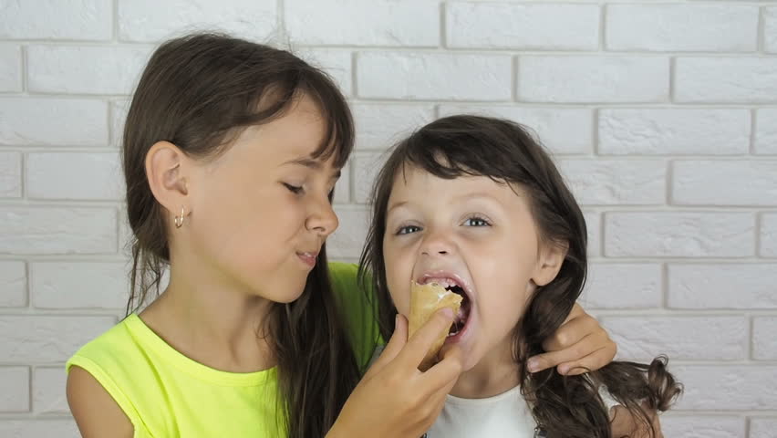 Children with ice cream. Little girls eat ice cream. | Shutterstock HD Video #1013687798