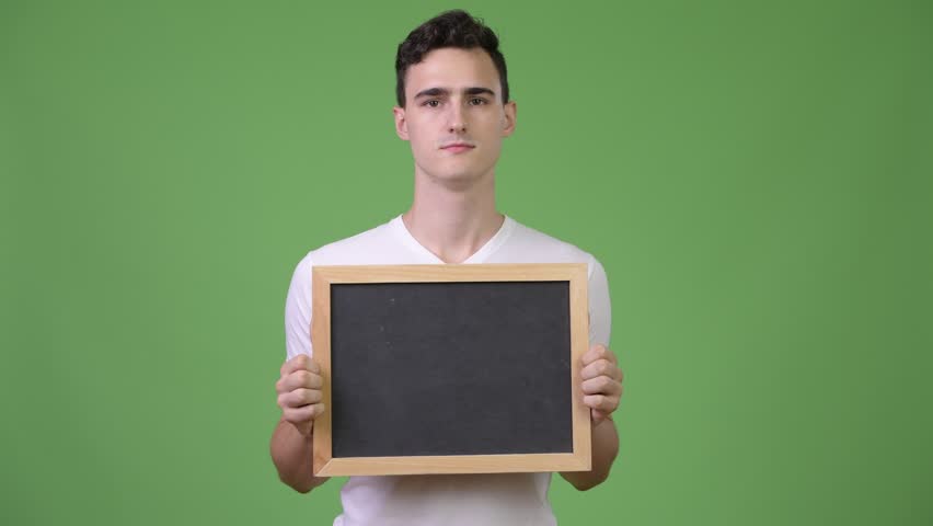 Young happy handsome man holding blackboard