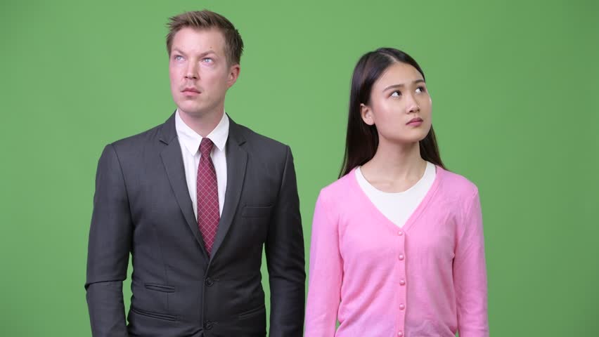 Young Asian woman and young businessman thinking together