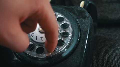 Calling on an old vintage rotation phone and dialing a number